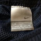 An early to mid 2000s vintage Nike tag showing the Swoosh logo
